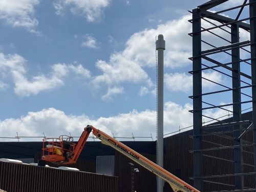 Smokestack with TMD. The TMD reduces VIV by increasing the Scruton number.


Smokestack TMDs are sometimes hidden inside the cylindrical stack, typical for large diameter multi-pipe stacks. Here, the TMD is in the annular chamber near the stack top.